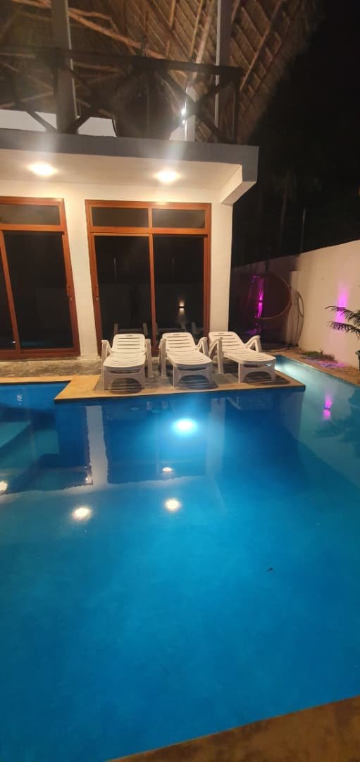 The GALLAH Hotels pool lit up at night